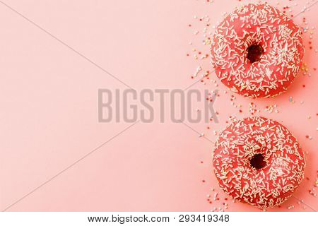 Two Coral Donuts. Donuts With Icing On Pink Background.