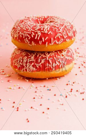 Two Coral Donuts Standing In A Line. Donuts Decorated With Icing