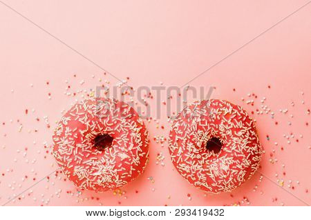 Two Coral Donuts. Donuts With Icing On Pink Background.