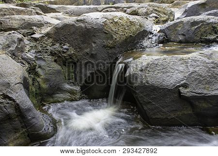 The Water Flowing Over Rocks And Trees Down A Waterfall At Khao Ito Waterfall , Prachin Buri In Thai