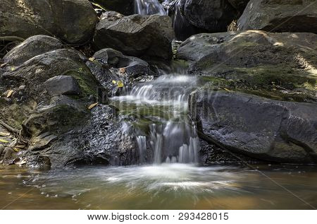 The Water Flowing Over Rocks And Trees Down A Waterfall At Khao Ito Waterfall , Prachin Buri In Thai