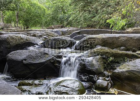 The Water Flowing Over Rocks And Trees Down A Waterfall At Khao Ito Waterfall , Prachin Buri In Thai
