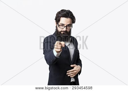 Bearded Businessman Points His Finger At You. Serious Guy Looking At Camera And Pointing To The Fron