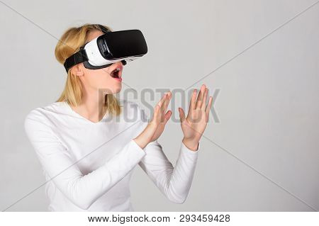 Woman Wearing Virtual Reality Goggles. Person With Virtual Reality Helmet Isolated On Grey Backgroun