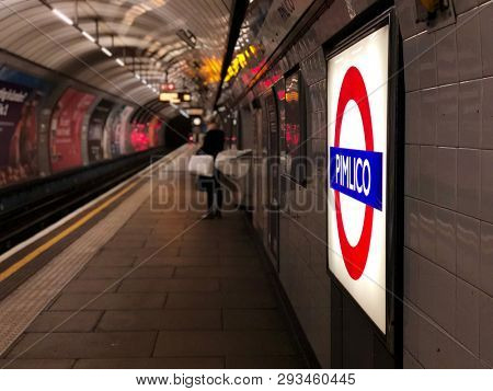 PIMLICO, LONDON - APRIL 2, 2019: A passenger waiting for a train on a quiet Victoria Line platform at Pimlico Underground Station in London, UK.