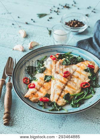 Grilled Sea Bream Fish Fillet With Spinach And Chili Pepper