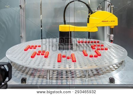 Hannover , Germany - April 02 2019 : A Robot Is Is Laying The Word Fanuc At The Hannover Fair Showin