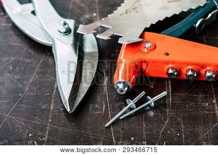 Tinsmith tools on the working table in the factory