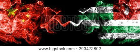 China Vs Abkhazia, Abkhazian Smoke Flags Placed Side By Side. Thick Colored Silky Smoke Flags Of Chi