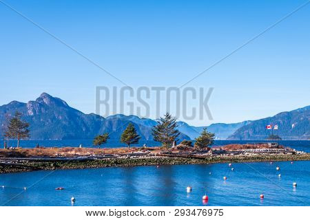 Fantastic view over ocean, snow mountain and rocks at Sechelt inlet in Vancouver, Canada.