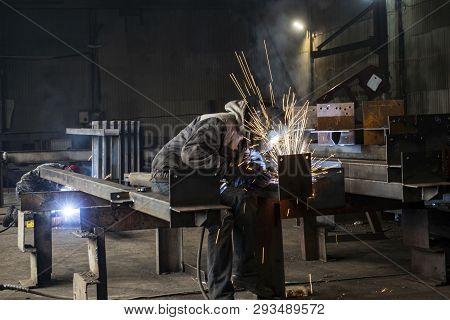 Welding With Sparks By Process Fluxed Cored Arc Welding , Industrial Steel Welder Part In Factory We