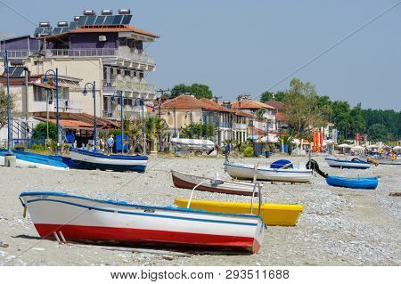 Leptokaria, Pieria, Central Macedonia, Greece - 07th May 2015: fishing boats and cafe at the beach just before the high season