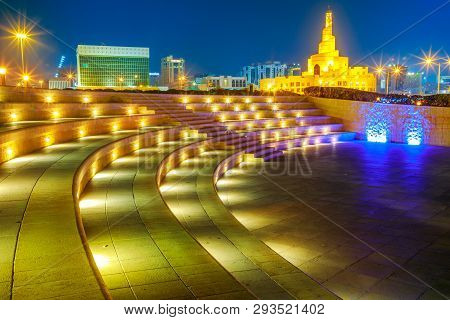 Stairs Of Amphitheater At Souq Waqif Garden Near Doha Corniche With Doha Mosque Illuminated At Night