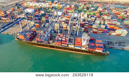 Container Shipping Boat At Dock Yard Main Logistics System Of Transportation Of Cargo Container.