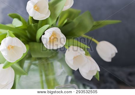 Bouquet Of White Tulips In A Vase On A Gray Background. Flowers As A Gift For Your Favorite Person. 