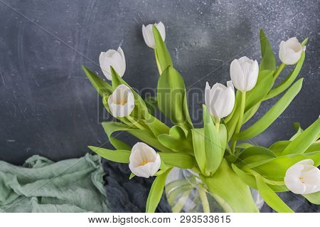 Bouquet Of White Tulips In A Vase On A Gray Background. Flowers As A Gift For Your Favorite Person. 