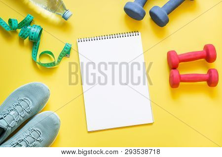 Sport And Fitness Equipment, Dumbbells, Fitness Shoes, Measuring Tape On Punchy Yellow.