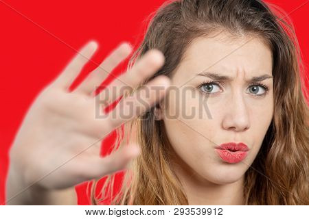 A Portrait Of A Beautiful Girl Showing Stop Sign With Palm