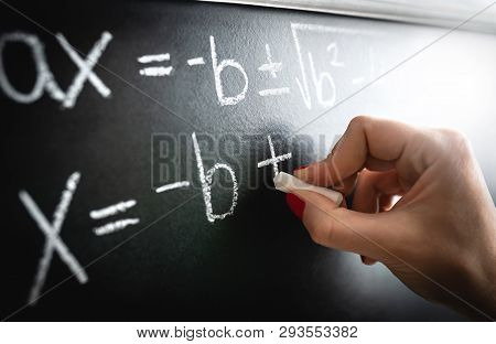 Math Equation, Function Or Calculation On Chalkboard. Teacher Writing On Blackboard During Lesson An