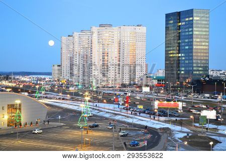 Beautiful Cityscape With Urban Downtown Of Minsk, Belarus. Night Sky With Big Lune. Urban Landscape 