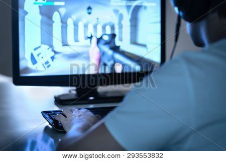 E Sports And Gaming Concept. Gamer Playing Fps Video Game With Computer And Wearing Headphones. Prof
