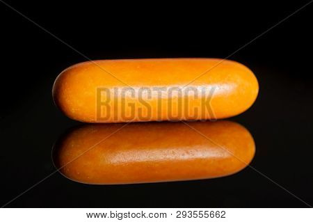 One Whole Orange Sweet Licorice Comfit Isolated On Black Glass