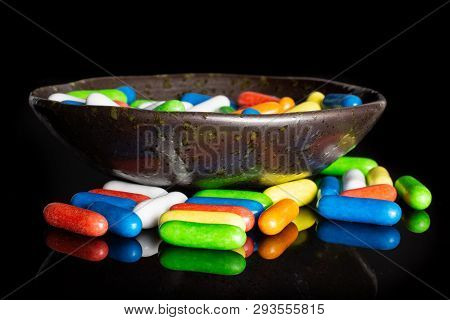 Lot Of Whole Sweet Licorice Comfit Isolated On Black Glass