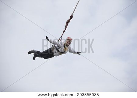 Belarus, Gomel, March 08, 2019. Jumping From The Bridge To The Rope.ropejumping.an Elderly Woman Jum