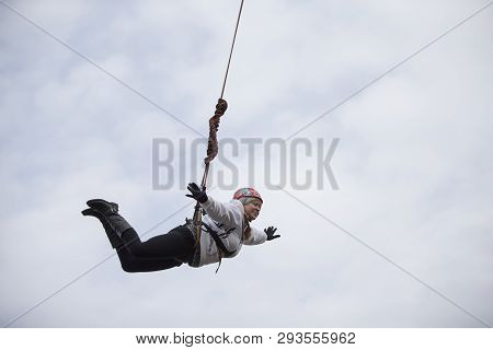 Belarus, Gomel, March 08, 2019. Jumping From The Bridge To The Rope.ropejumping.an Elderly Woman Jum