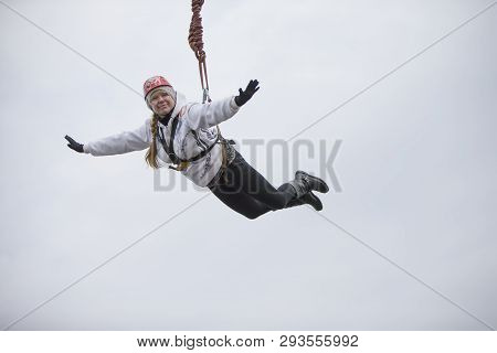 Belarus, Gomel, March 08, 2019. Jumping From The Bridge To The Rope.ropejumping.an Elderly Woman Jum