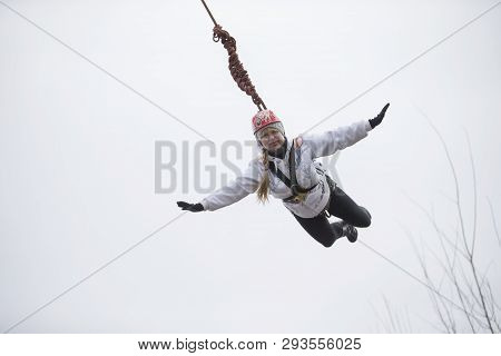 Belarus, Gomel, March 08, 2019. Jumping From The Bridge To The Rope.ropejumping.an Elderly Woman Jum