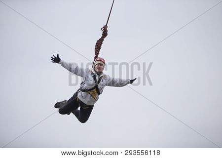 Belarus, Gomel, March 08, 2019. Jumping From The Bridge To The Rope.ropejumping.an Elderly Woman Jum