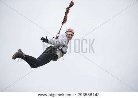 Belarus, Gomel, March 08, 2019. Jumping From The Bridge To The Rope.ropejumping.an Elderly Woman Jum