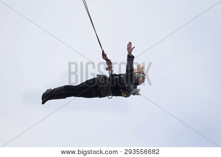 Belarus, Gomel, March 08, 2019. Jumping From The Bridge To The Rope.ropejumping.an Elderly Woman Jum
