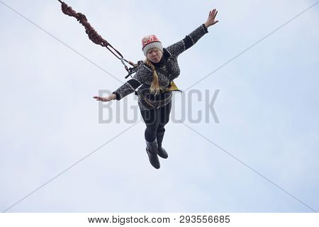 Belarus, Gomel, March 08, 2019. Jumping From The Bridge To The Rope.ropejumping.an Elderly Woman Jum