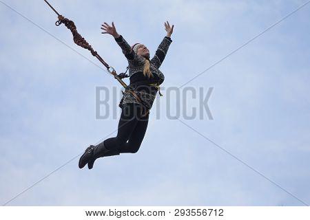 Belarus, Gomel, March 08, 2019. Jumping From The Bridge To The Rope.ropejumping.an Elderly Woman Jum