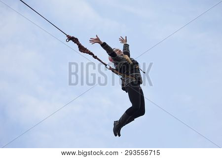 Belarus, Gomel, March 08, 2019. Jumping From The Bridge To The Rope.ropejumping.an Elderly Woman Jum