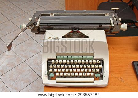 Vintage Mechanical Typewriter Machine At Desk In Retro Office
