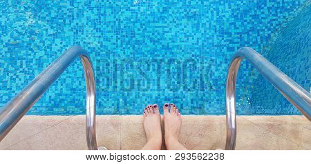 Two Female Bare Feet Standing On The Edge Of Swimming Pool Half Ready To Enter