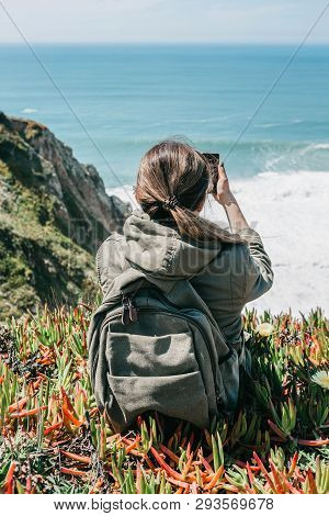A Tourist Girl Or A Traveler With A Backpack Makes A Photo Or Talks On An Online Chat Or Tells Subsc