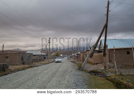 Sary-mogul, Kyrgyzstan - October 7, 2014: Gravel Road And Houses In The Village Sary-mogul In South 
