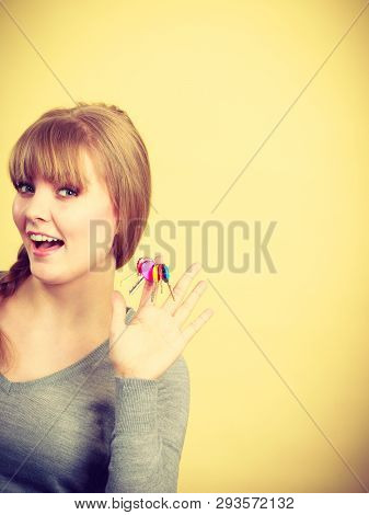 Ownership And Property Concept. Young Blonde Smiling Female Owner With Bunch Of Colorful Keys. Woman