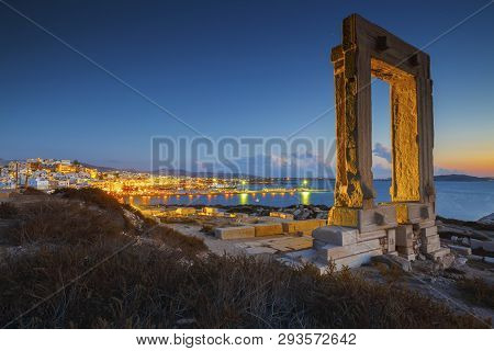 View Of Portara And Remains Of Temple Of Apollo At Sunset.