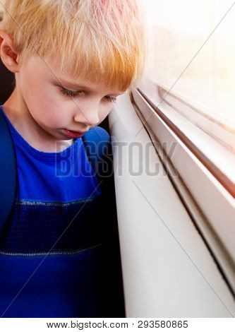 Sad Blond Child Boy Sit In The Train By The Window