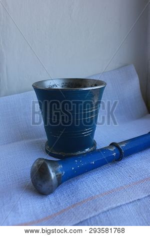 Ancient Metal Mortar With Pestle On Linen Background