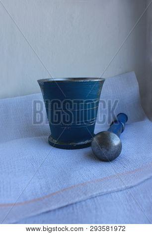 Ancient Metal Mortar With Pestle On Linen Background