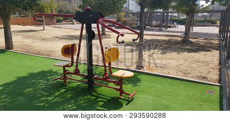 Sports Equipment For Training For Two People On Green Grass In Outdoor Gym At City Park
