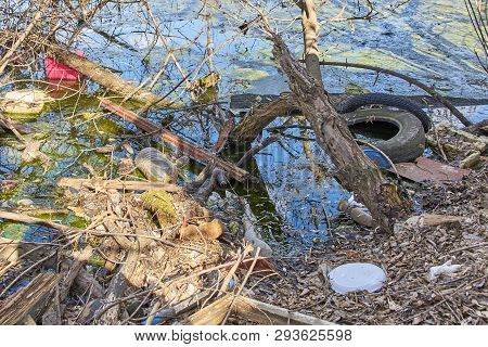 Garbage Thrown To The Bank Of The River, The Topic Of Environmental Pollution