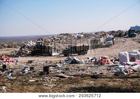 Dump Truck Unloading Waste On A Landfill