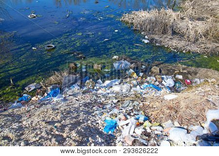 Garbage Thrown To The Bank Of The River, The Topic Of Environmental Pollution